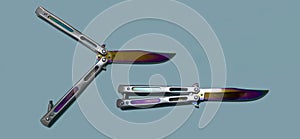 Knife type balisong or butterfly or fan on blue background