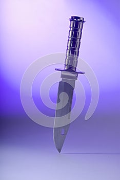 Knife on violet background