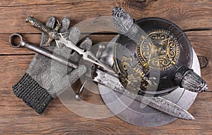 Knight armor, sword and shield on wooden