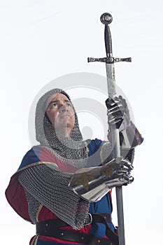 Knight bowing with sword, vertical