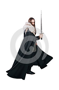 A knight in chain mail and with a fur collar in a black cloak on a white background in full growth. Viking man with long hair and