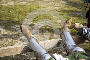 Knight feet in steel boots medieval warrior equipment for fight and war action event