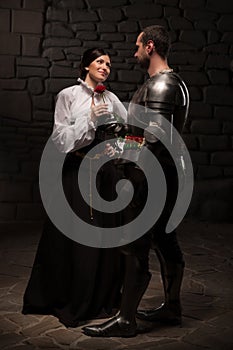 Knight giving a rose to lady