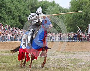 Knight in heavy armor on a horse and with a lance