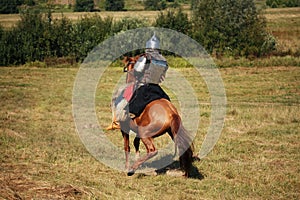 Knight on horse. Medieval armored equestrian soldier. Rider is in the summer