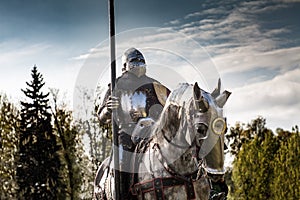 Knight on horseback. Horse in armor with knight holding lance.