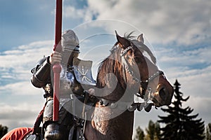 Knight on horseback. Horse in armor with knight holding lance. Horses on the medieval battlefield.