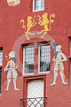 Knight and lion ornaments on the red facade of the town hall in Bad Muenstereifel