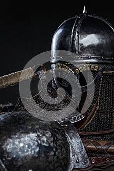 Knight medieval armor and axe against dark background