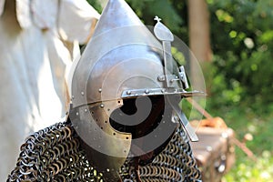 Knight`s armor: helmet and chain mail on a blurry background.