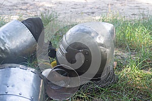 Knight`s helmet on the green grass day