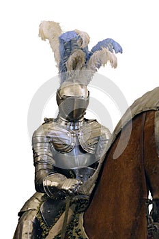 Knight in shining steel armor and a helmet with feathers on the horse isolated