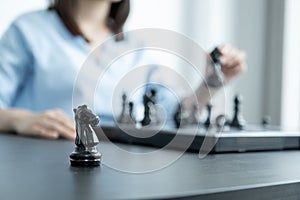 Knight standing in front of people hand move chess with strategy and tactic to win enemy, play battle on board game, business