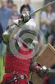 Knight in steel armor with a sword in hand and shield