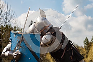 Knight tournament. The knights in the congregations are fighting in the ring. Public event in the city.