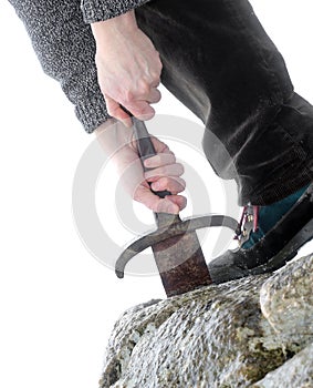 Knight tries to remove Excalibur sword in the stone