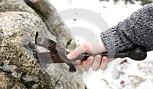 Knight tries to remove Excalibur sword in the stone