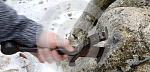 Knight tries to remove Excalibur sword in the stone