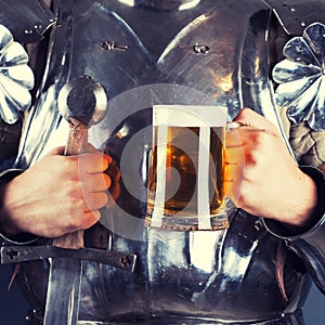 knight wearing armor and holding mug of beer and two-handed sword