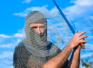 Knight wearing armour and hold on a sword