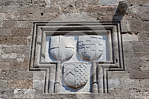 Knightly coat of arms on the wall of a house in Rhodes.