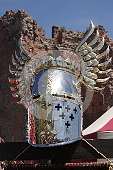 Knightly helmet and ruins of a fortress photo