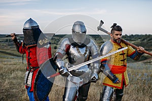 Knights with swords and axe poses in armour