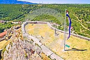 Knin fortress plateau nad large croatian flag aerial view