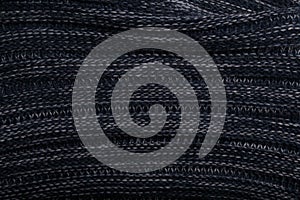 Knit dark blue fabric texture, background or backdrop. Textile, scarf or sweater textured surface. Warm accessories, clothing