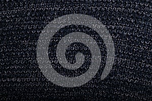 Knit dark blue fabric texture, background or backdrop. Textile, scarf or sweater textured surface. Warm accessories, clothing