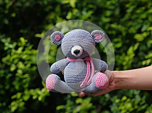 A knit doll resembles a cute little bear cub made from yarn