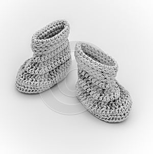 Knitted baby booties on white