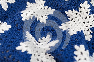 Knitted blue and white ornament with snowflakes