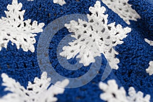 Knitted blue and white ornament with snowflakes