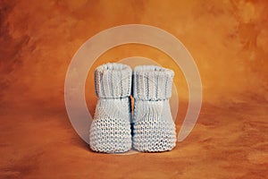 Knitted booties for newborn baby. Baby birth concept.