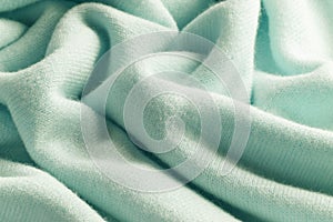 Knitted cashmere green fabric texture with large fold