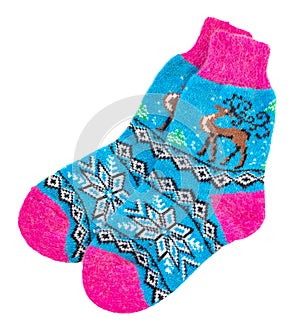 Knitted Christmas socks with pattern. Women`s warm socks isolated on white background.