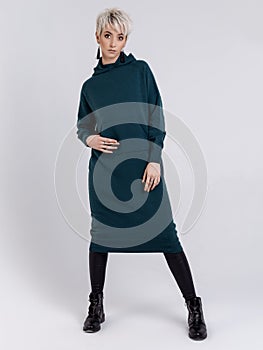 Knitted clothes on show on the girl in the studio on a white background