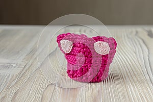 Knitted crochet small pink hat. Women`s hat for feminists march protest. Creative craft work