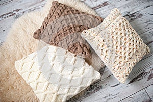 Knitted cushions of natural shades