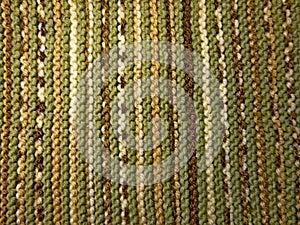 Knitted fabric texture. Background image. Hobbies, leisure, crafts. Green and brown