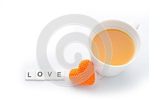 Knitted fabrics heart shape, love message and orange juice isolated on white background