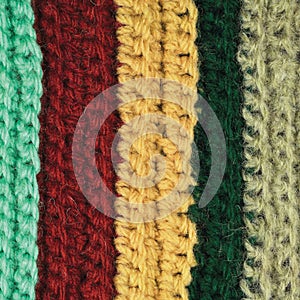 Knitted fine wool garment colorful stripes background natural texture, yellow, beige, claret, blue, green scarf macro closeup