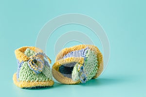 Knitted green baby booties for little boy