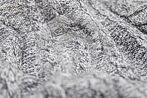 Knitted grey fabric texture with a relief pattern