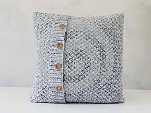 Knitted grey pillow with wooden buttons