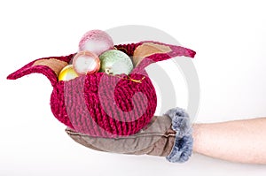 Knitted hat with Christmas decorations on hand