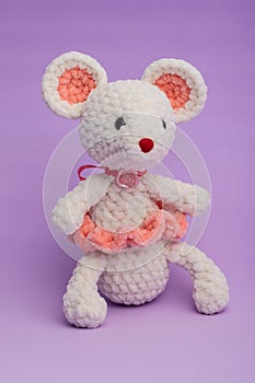 Knitted with his hands toy mouse on a lilac background