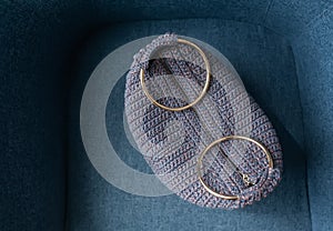 Knitted ladies` purse of blue color with rings. Top view