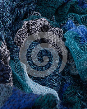 Knitted layers of Multi Blue Wools all crumpled Background